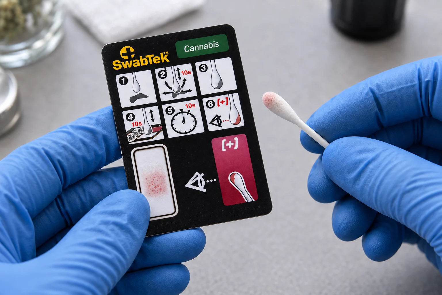 Illustrative faint pink positive indication on the Cannabis reagent pad and swab tip